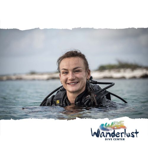 Diver smiling at the surface in calm water during a Wanderlust Dive Center training session