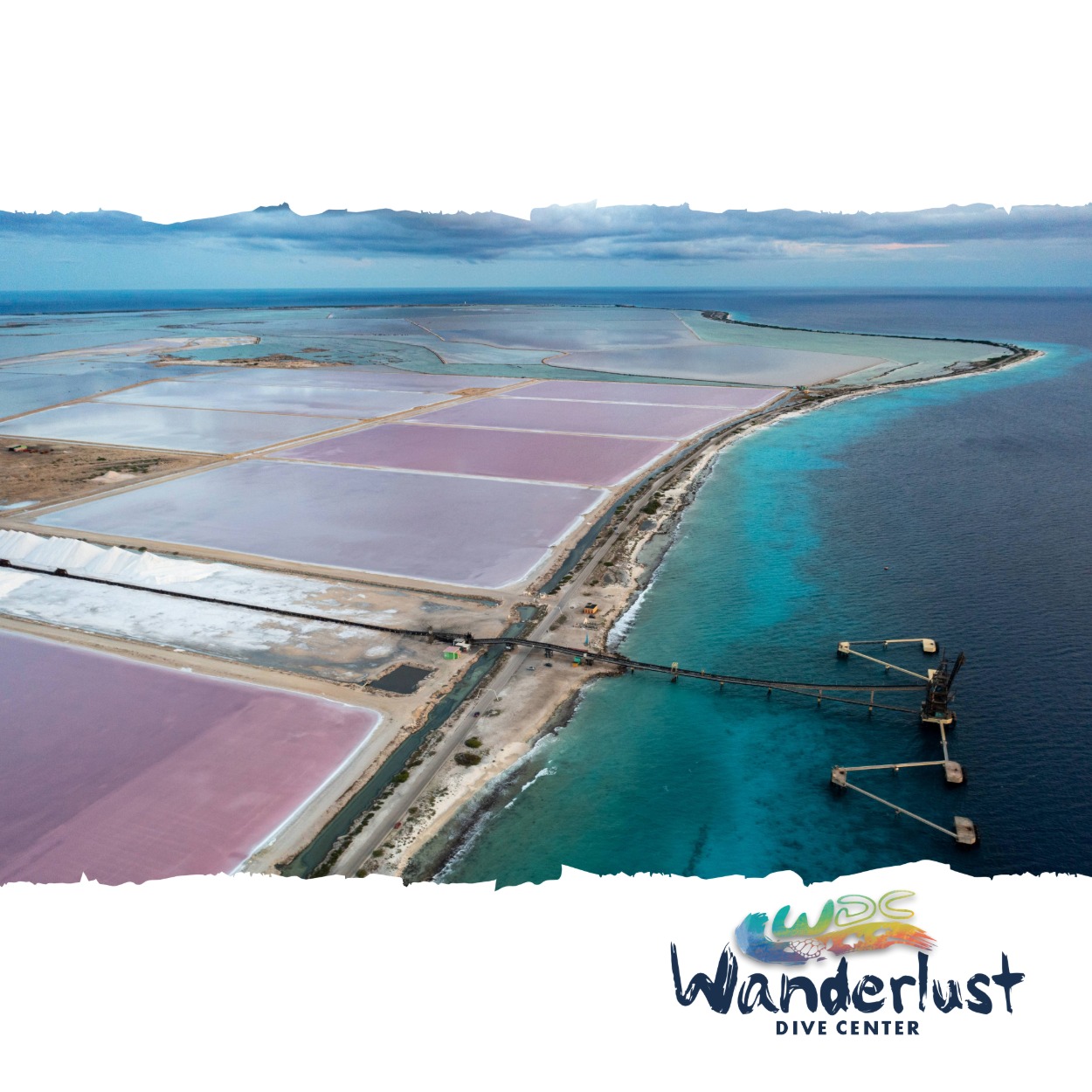 Aerial view of Bonaire’s salt pans with turquoise coastline and coastal road